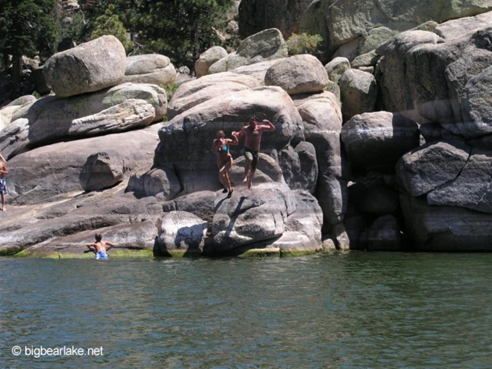 Mum and dad jump from the rocks near the dam